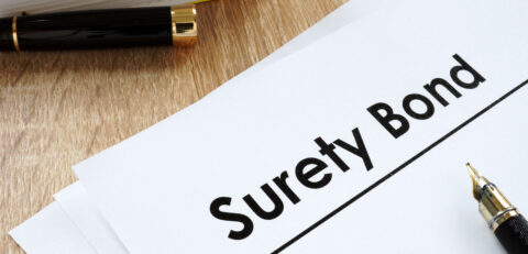 Surety bond form and pen on a table.